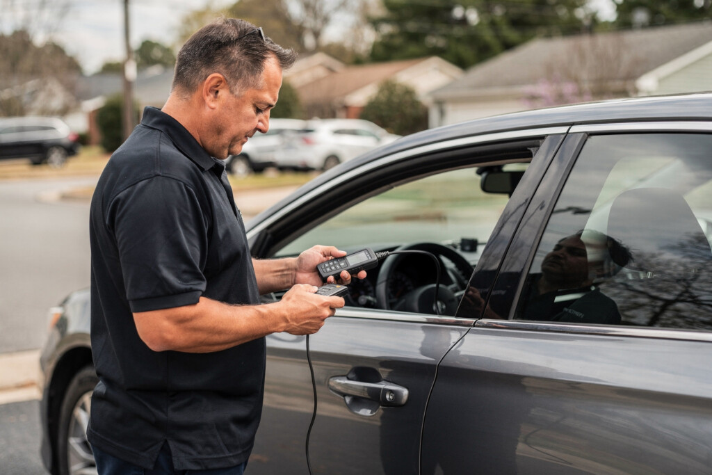 Mobile locksmith programming a car key fob in Charlotte, NC